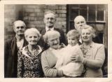 Mrs Sturgess in front her shop  in the High St. with members of her family